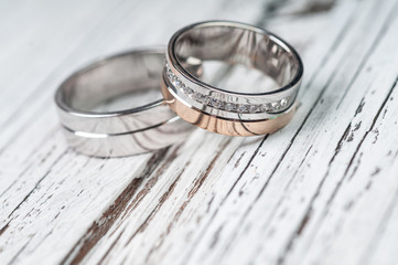 Wedding rings on rustic wood - 114354458