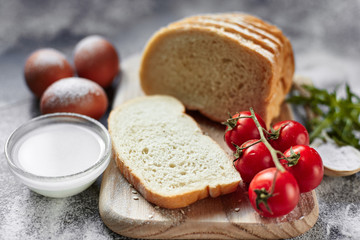 Ingredients for the preparation of bakery products. Bread, flour, eggs and cherry tomatoes.