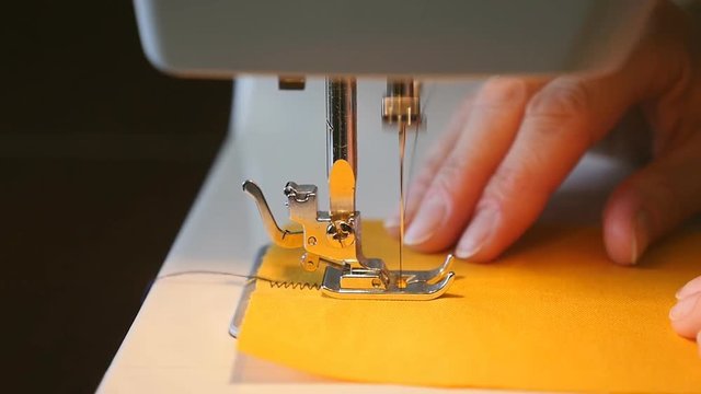 Woman sewing on the sewing machine - slow motion 