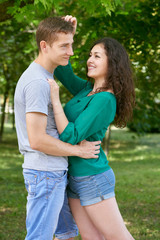 Romantic couple posing in city park, summer season, lovers boy and girl