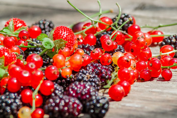 black mulberry, red currant, a wooden table