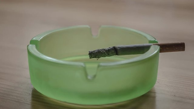 Burning cigarette in the ashtray - timelapse 