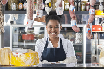 Portrait Of Happy Saleswoman In Cheese Shop