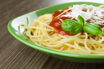 Cooked spaghetti with traditional italian tomato sauce served in