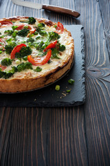 Vegatable pie ( quiche) with broccoli, tomatoes and soft cheese