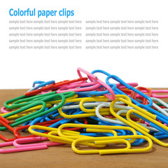 Paper clips on table isolated on white background