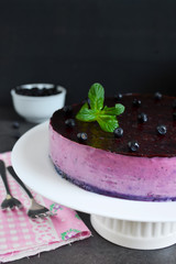 Blueberry mousse cake on a black background