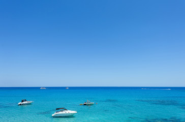 Fototapeta na wymiar Photo of sea in protaras, cyprus island with boats and immaculate water.
