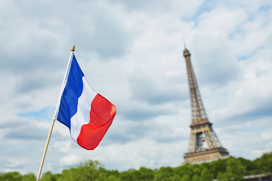 French national flag (tricolour) in Paris with the Eiffel tower in the background