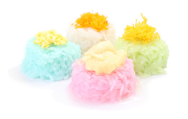 Multiple color of sticky rice with custard on white floor.