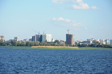 Fototapeta premium A construction of new houses on the river bank