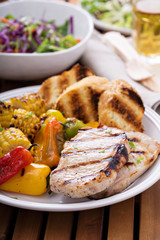 Grilled pork chops with vegetables and bread