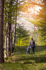 Fototapeta premium Mother walks in the forest with a child