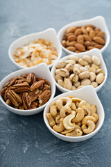 Variety of nuts in small bowls
