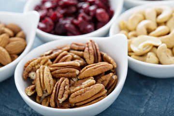 Variety of nuts and dried fruits in small bowls