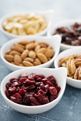 Variety of nuts and dried fruits in small bowls