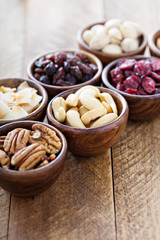 Fototapeta na wymiar Variety of nuts and dried fruits in small bowls