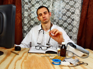 Male doctor showing condom