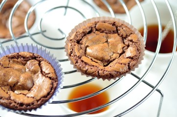 freshly baked chocolate muffins cooling off on wire mesh