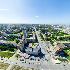 Aerial city view with crossroads and roads, houses, buildings, parks and parking lots, bridges. Urban landscape. Copter shot. Panoramic image.