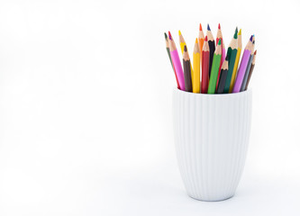Colored pencils in a white cup