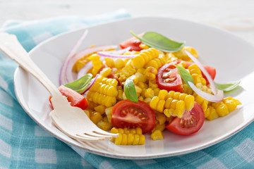 Salad with grilled corn, tomatoes and onion