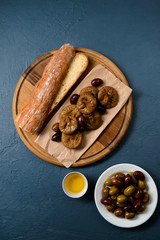 Fototapeta premium Bread long loaf, fig and dates on wooden board