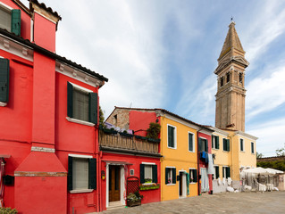 Fototapeta na wymiar The Venetian island of Burano may well be the most colorful town in the world, with no two houses next to each other painted the same color.