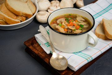 Tasty soup in pan over gray background. Close up.