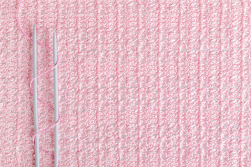 knitting needles on a background associated texture of yarn