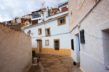 Fototapeta na wymiar Town with dwellings houses-caves built into rock. Alcala del J