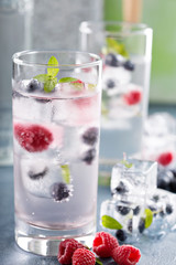 Sparkling water with berry and herb ice