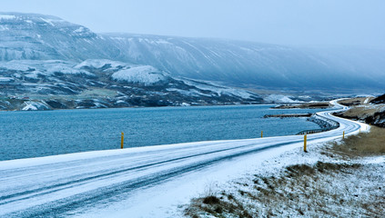frozen winding road the ocean shores in Iceland  