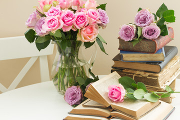 Old books with rose flower