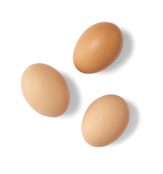 Food and ingredients - Whole brown and white chicken eggs isolated on a white background