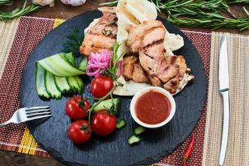 The view from the top dinner of fried bacon and zucchini with tzatziki sauce served on a stone Board