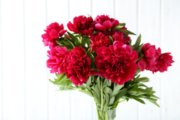 Bouquet of red peony flowers on wall paneling background