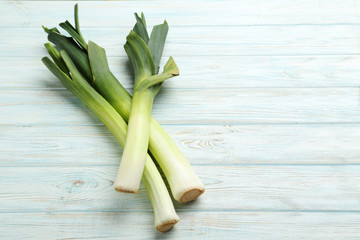 Green leeks on a grey wooden table