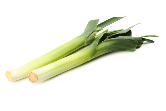 Green leeks on a grey wooden table