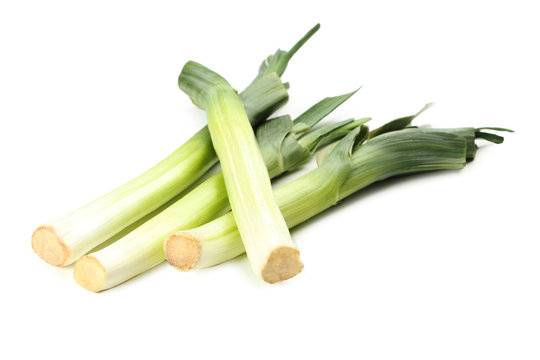 Green leeks on a grey wooden table