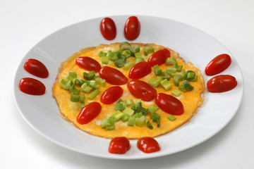 Omelette with cherry tomatoes and green onion, isolated