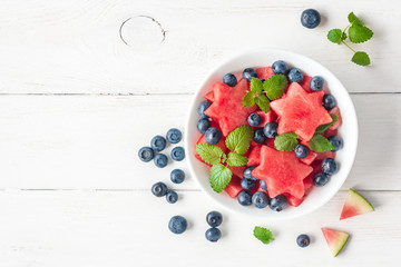 Fototapeta na wymiar Summer fruit salad of watermelon and blueberries, top view, flat lay