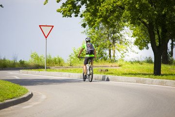 A man on a Bicycle with a backpack.
