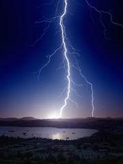 Naklejka na ściany i meble Weather background - bright powerful lightning, huge thunderbolt struck mountain near small seaside city