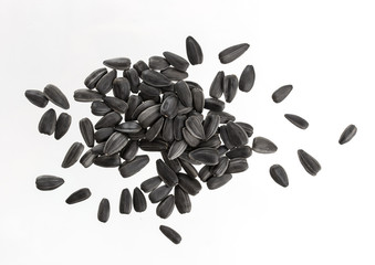 Heap of black sunflower seeds isolated on white background.