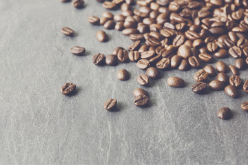 Coffee beans on stone with copy space, background