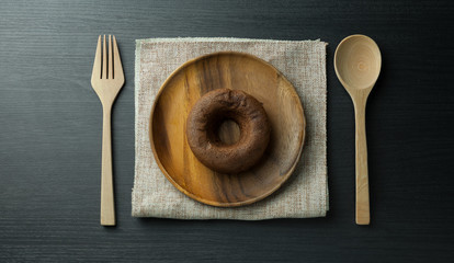Round wooden plate with sackcloth, wooden spoon, fork