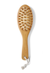 Cosmetic body and beauty tools - a wooden massage brush isolated on a white background