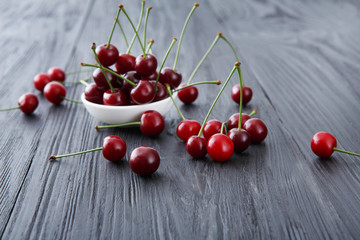 Fresh cherries closeup with green leaves on blue rustic wood