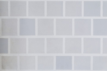Wall painted with light gray squares background.